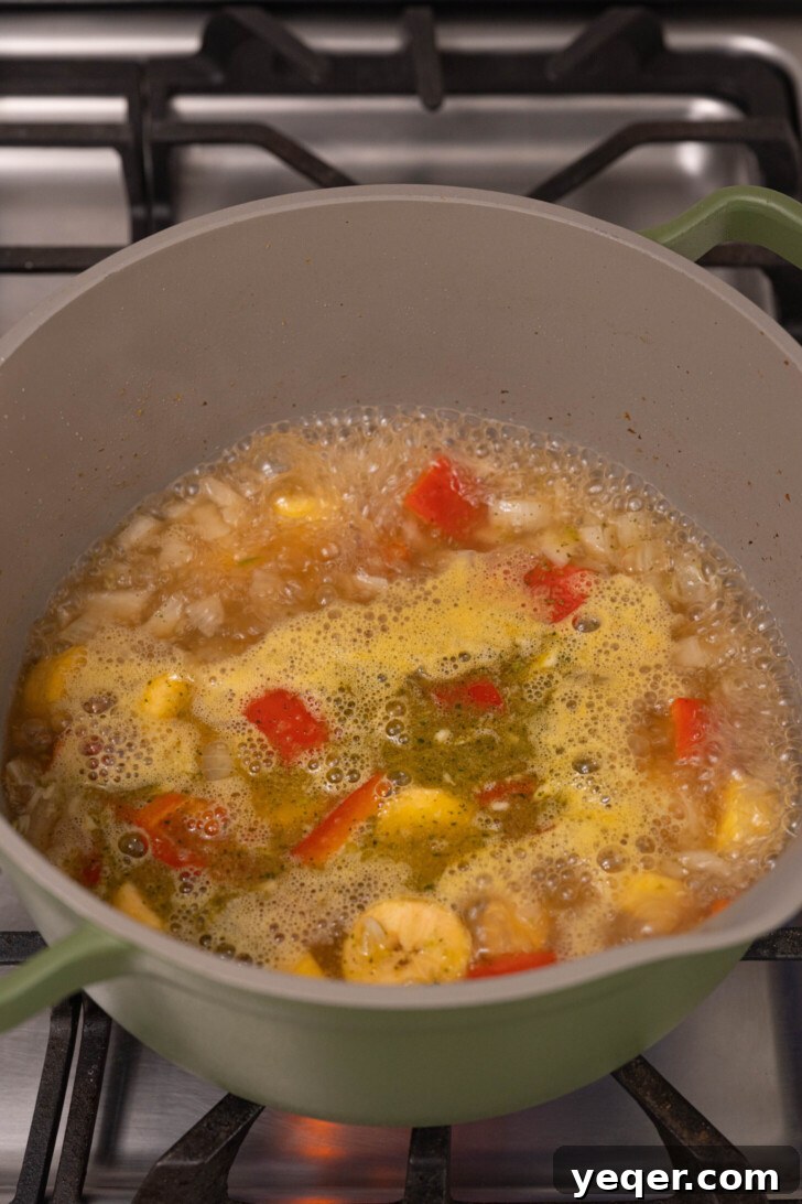 Plantain soup boiling in a pot.