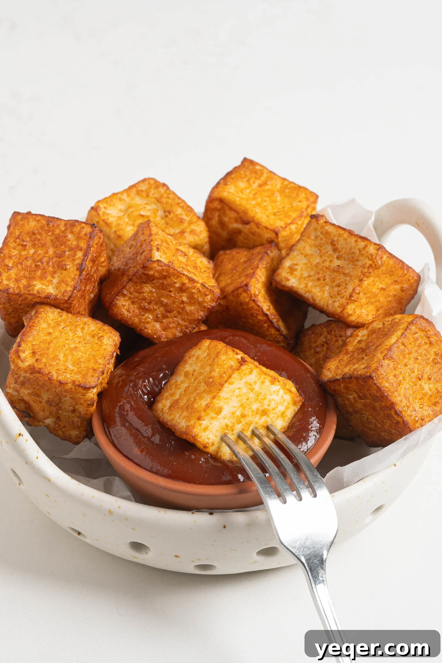 Crispy Queso Frito with Tropical Guava Drizzle 11 A beautifully presented bowl of queso frito with guava sauce, ready to be enjoyed as a gourmet snack.
