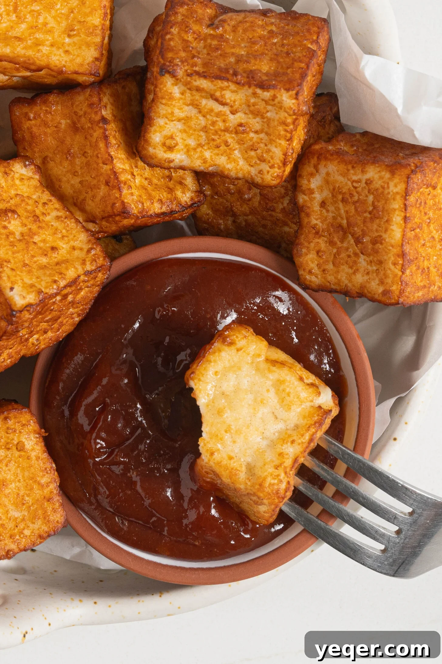 Crispy Queso Frito with Tropical Guava Drizzle 3 A close-up shot of golden-fried queso frito cubes glistening, ready to be served.