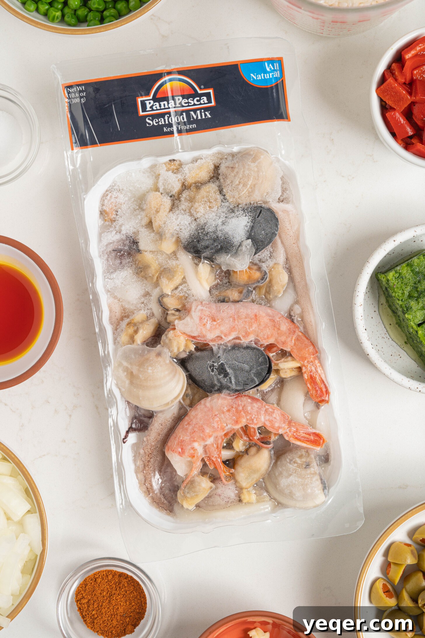 Vibrant Puerto Rican Seafood Rice 10 A transparent package of blended frozen seafood, showing shrimp, mussels, and calamari.