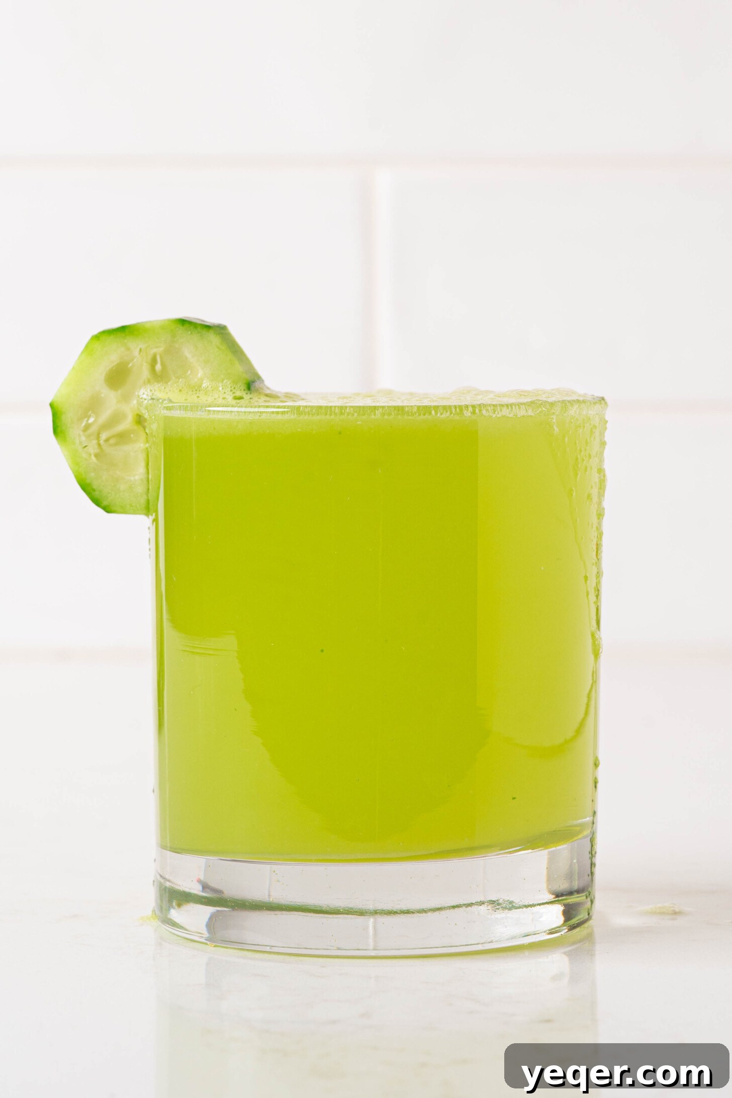 Cool Cucumber Lime Refresher 9 Another perspective of a glass of agua de pepino, showcasing its inviting green color and garnishes.