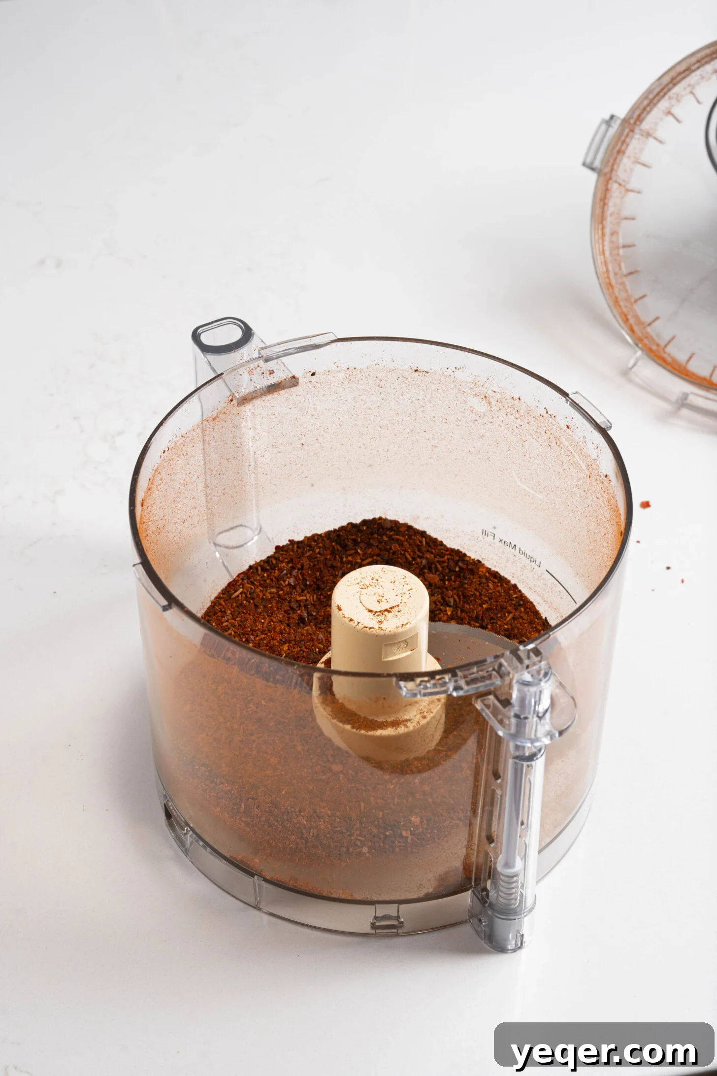 Homemade Harissa Spice Mix 9 A close-up of a food processor, showing the finely ground harissa seasoning.