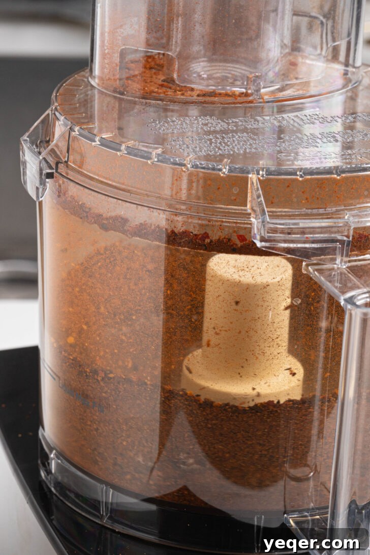 Homemade Harissa Spice Mix 8 A food processor filled with freshly ground harissa seasoning, rich and fine.
