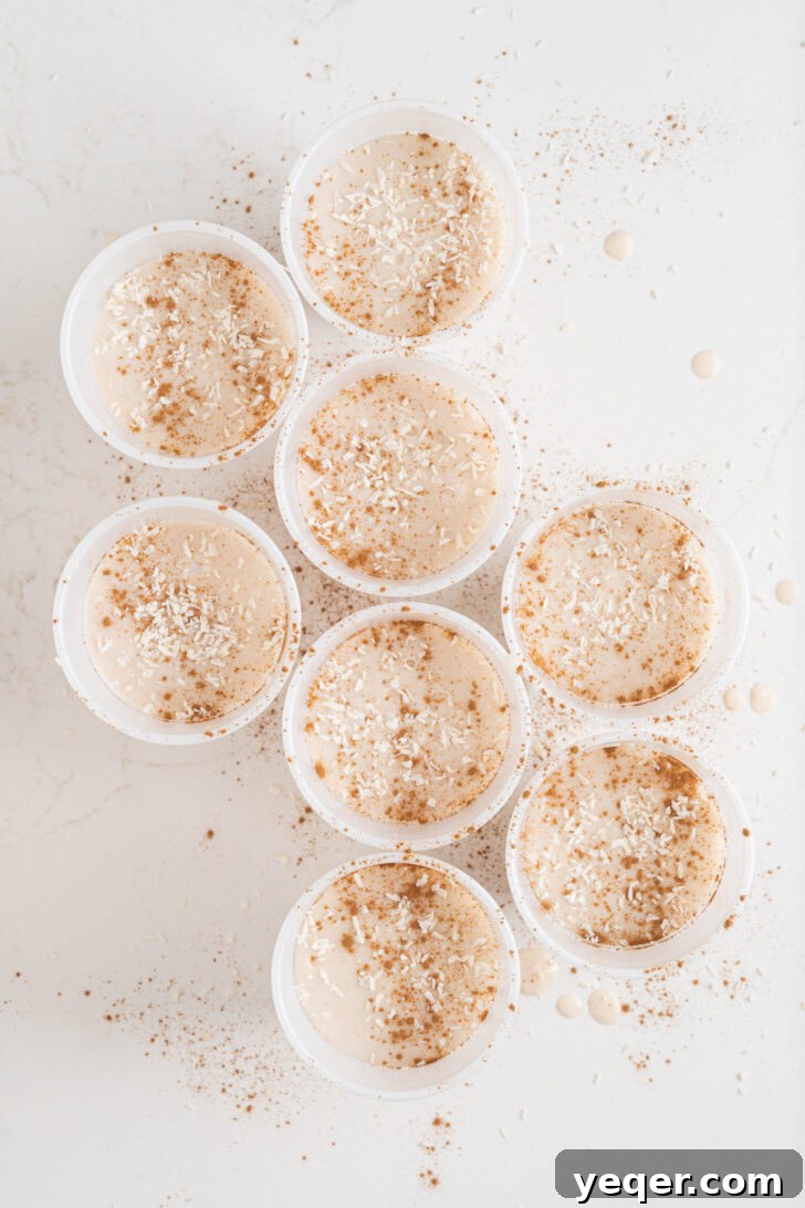 Puerto Rican Limber Coconut Pops 6 The blended Limber de Coco mixture poured into small plastic cups, garnished with shredded coconut, and ready for freezing.