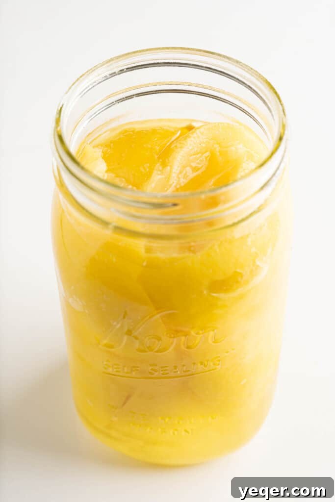 Moroccan Preserved Lemons An Authentic Homemade Recipe 5 a jar of preserved lemons being topped with lemon juice