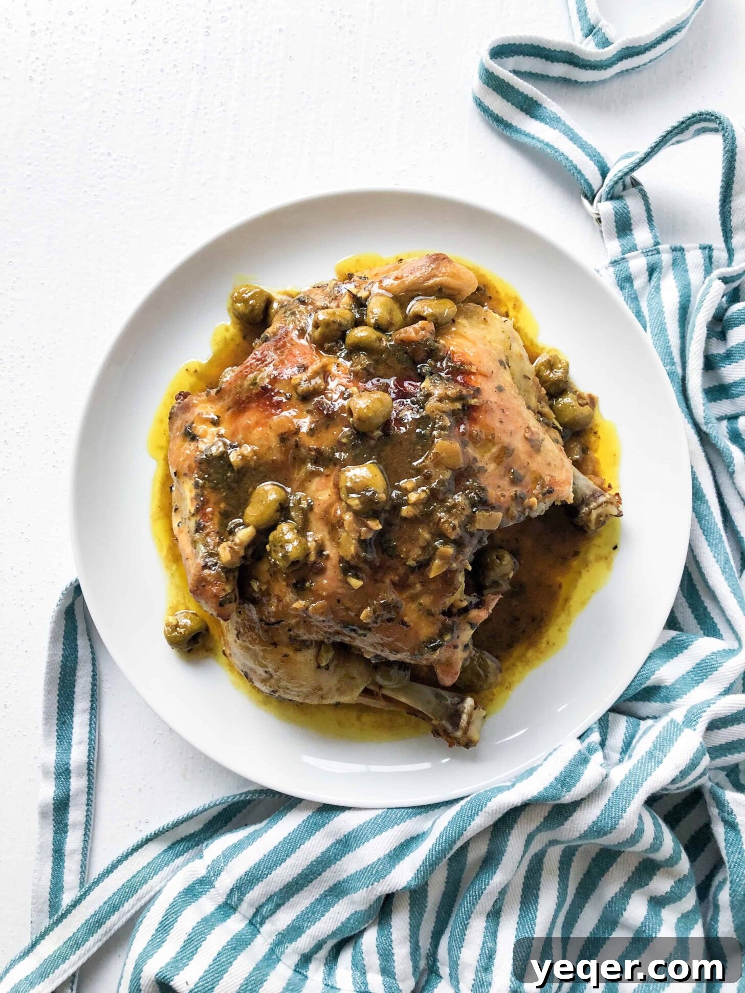 Zesty Moroccan Lemon Chicken with Olives 2 Moroccan chicken with olives on a plate with a striped towel