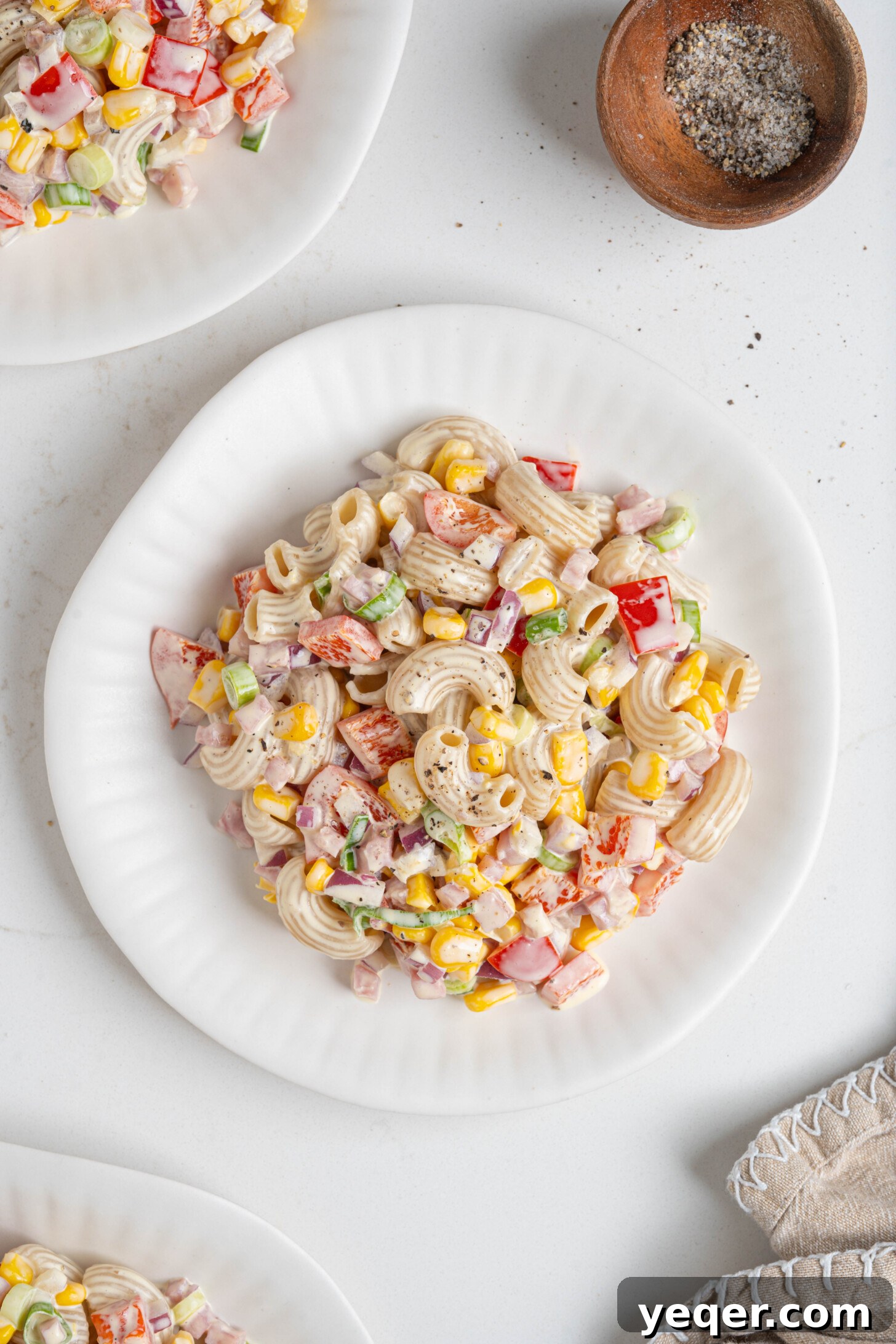 Signature Puerto Rican Macaroni Salad 8 A beautifully presented plate of Ensalada de Coditos, showcasing its vibrant colors and creamy texture, ready to be enjoyed.