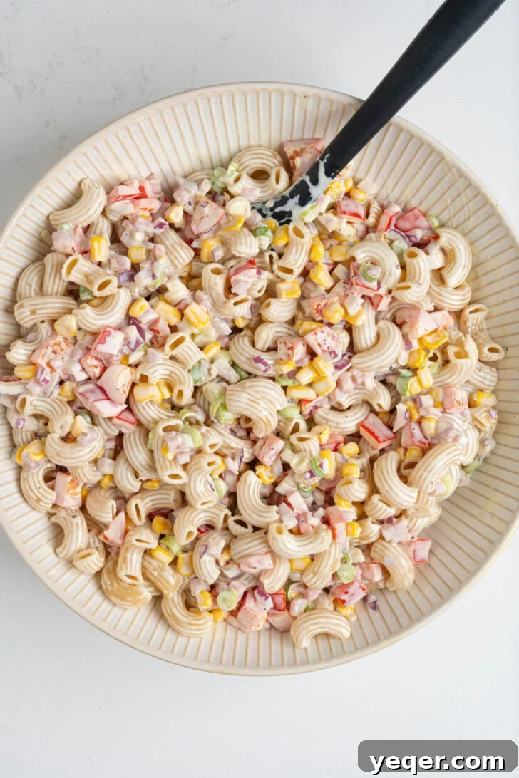 Signature Puerto Rican Macaroni Salad 7 A freshly prepared bowl of creamy macaroni salad, Ensalada de Coditos, showcasing its vibrant colors, ready to be served.