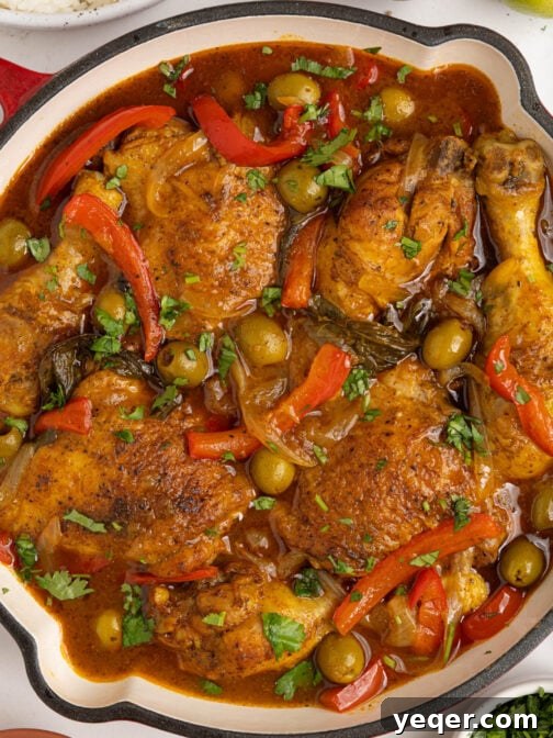 Pollo Guisado, a traditional Puerto Rican chicken stew, in a rustic pot, ready to be served.