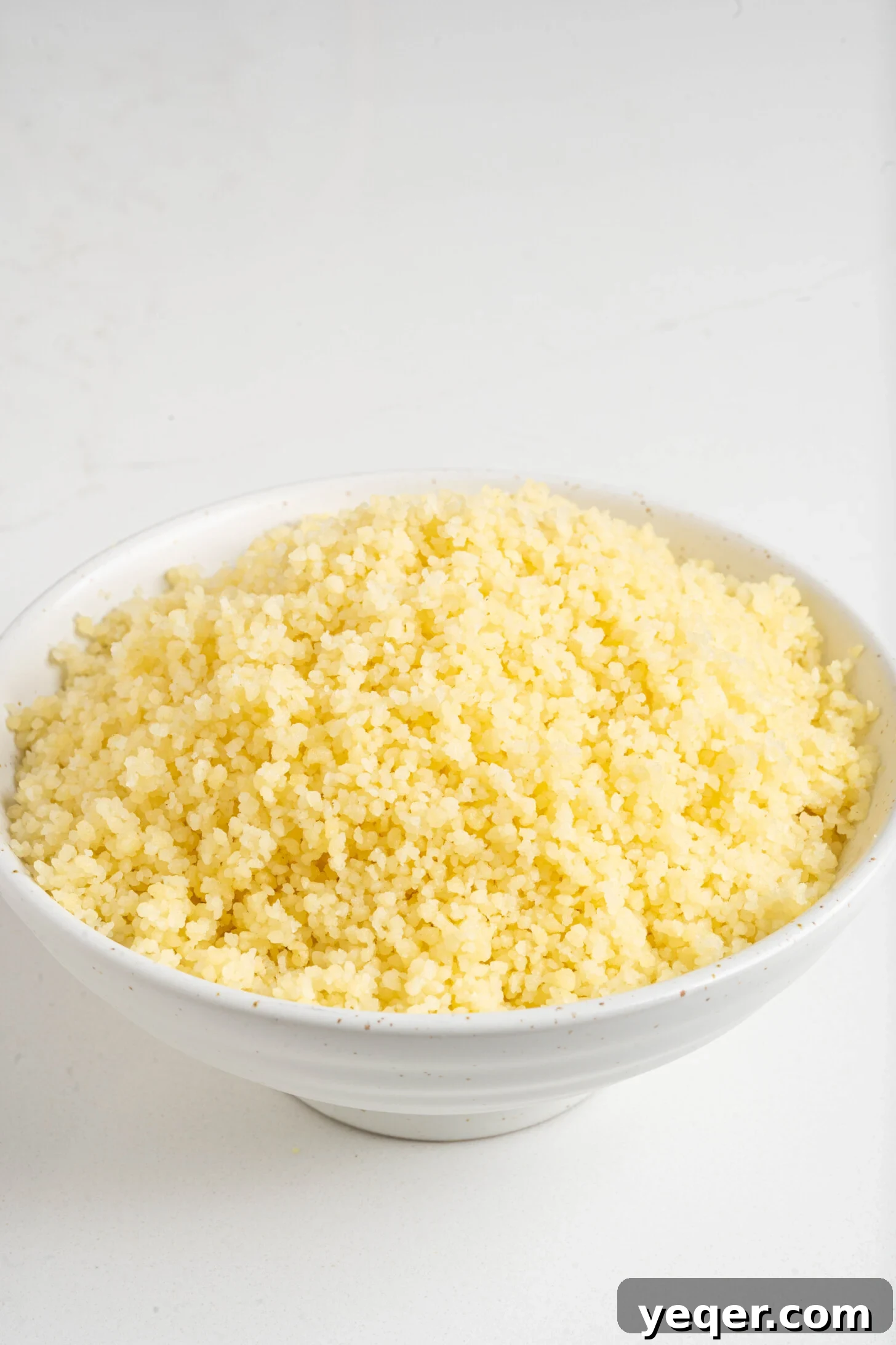The Secret to Perfectly Fluffy Couscous 13 A close-up shot of a bowl of fluffy couscous, emphasizing its perfect texture.