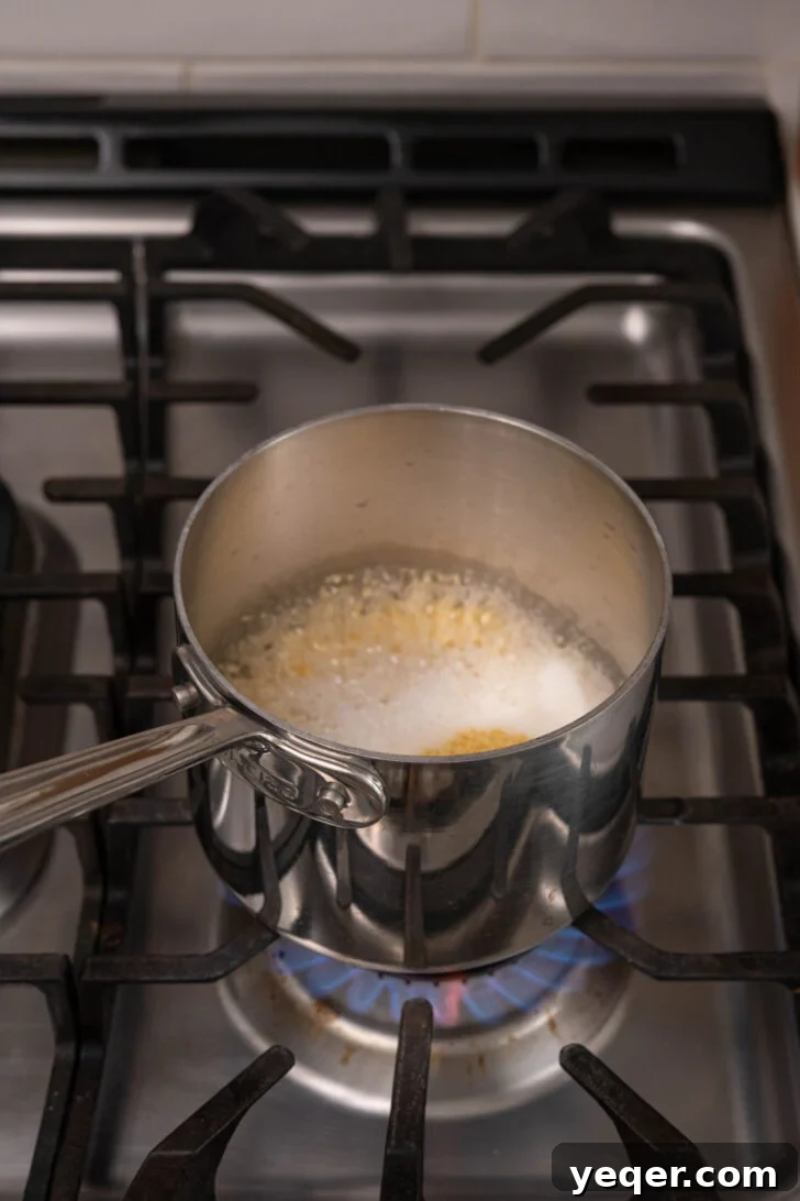 The Secret to Perfectly Fluffy Couscous 8 Dry couscous being poured into a pot of boiling water, then covered with a lid.