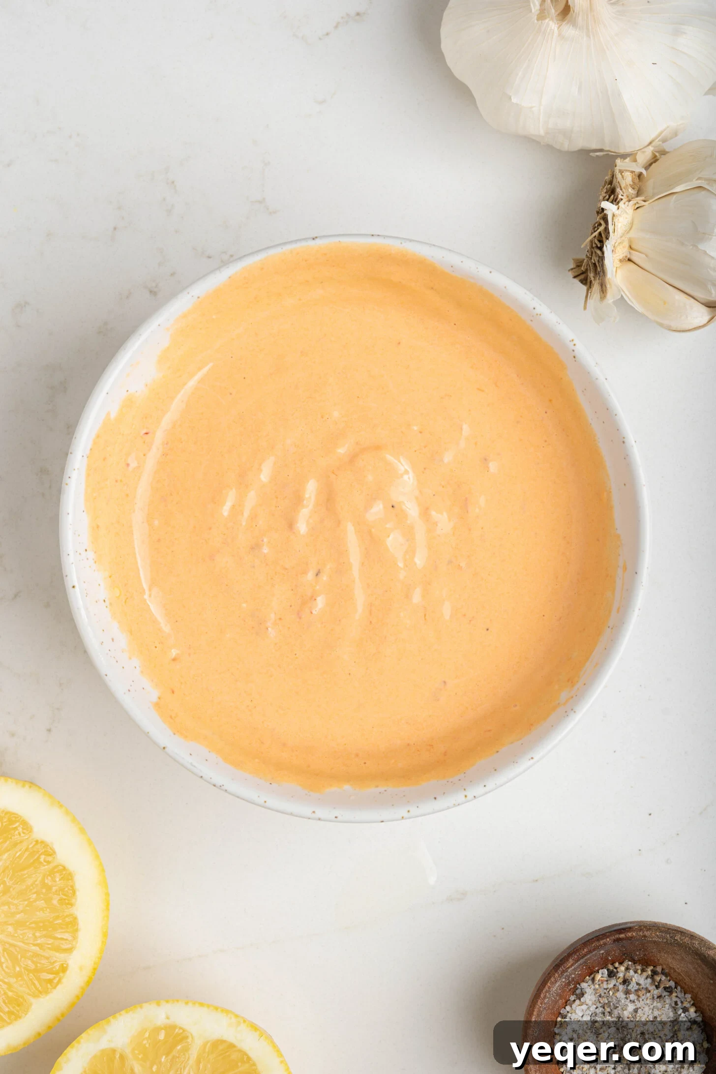 Quick Burst Harissa Garlic Aioli 7 A close-up shot of a bowl of creamy harissa aioli, emphasizing its rich texture and appealing color.