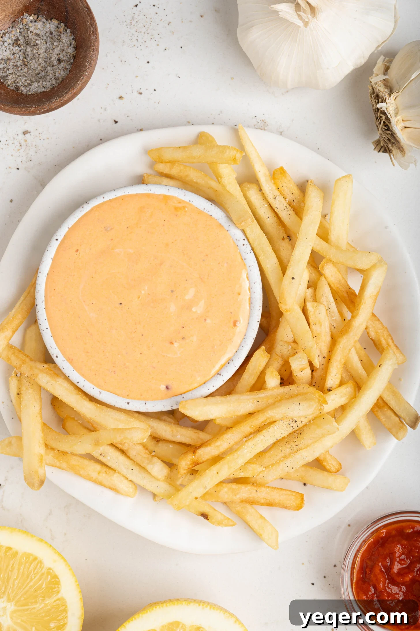 Quick Burst Harissa Garlic Aioli 8 A serving of crispy golden fries with a generous side of vibrant harissa aioli, perfect for dipping.