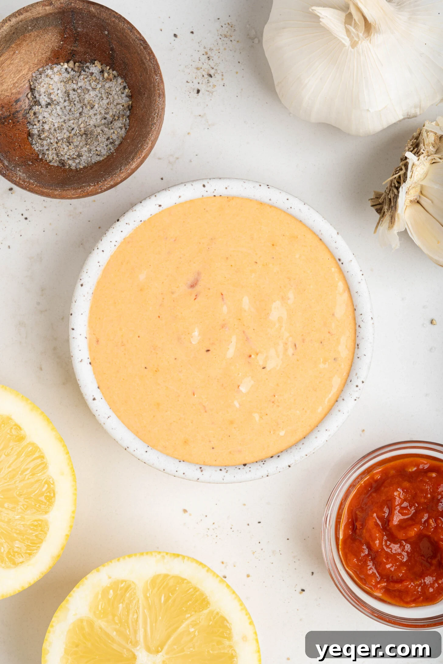 Quick Burst Harissa Garlic Aioli 3 A beautifully presented bowl of creamy red harissa aioli, showcasing its vibrant color and inviting texture.