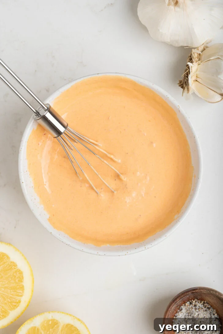 Quick Burst Harissa Garlic Aioli 6 A bowl of freshly whisked harissa aioli, showing its creamy, vibrant texture.