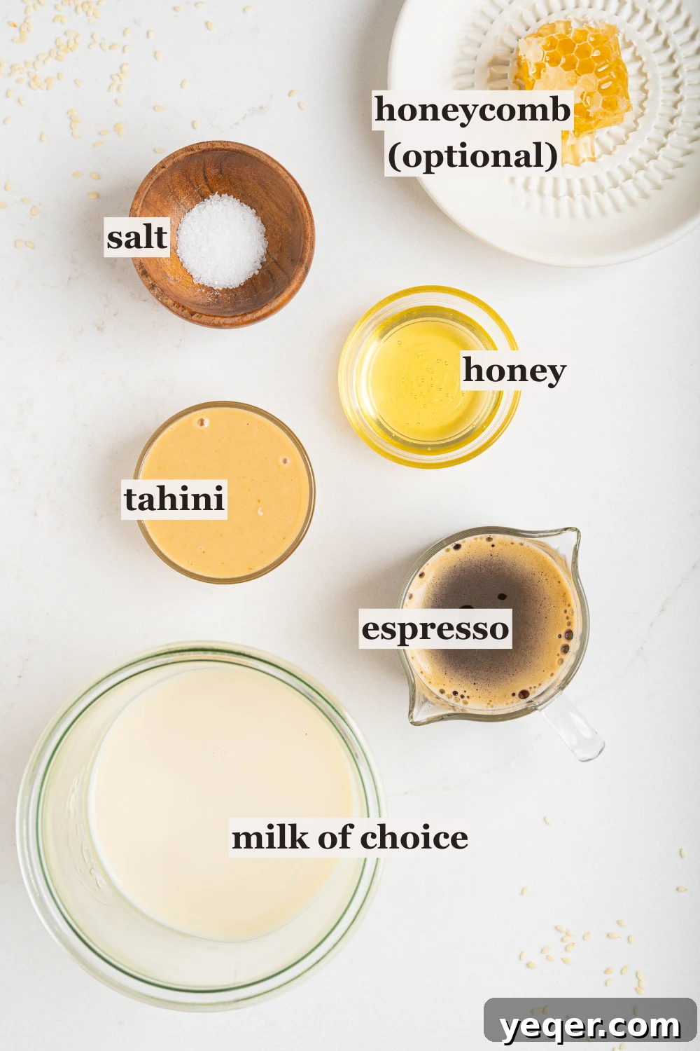 Salty Sweet Honeycomb Tahini Latte 3 Individual bowls holding honey, tahini, milk, and coffee beans, set against a rustic background, highlighting the simple ingredients required.