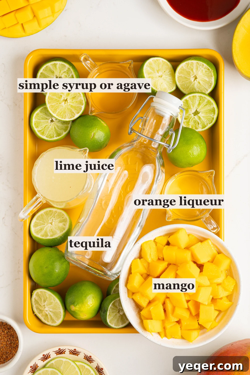 Golden Mango Margarita Bliss for All 3 Bowls of perfectly diced mango, freshly squeezed lime juice, and other margarita ingredients laid out on a clean surface, ready for mixing.