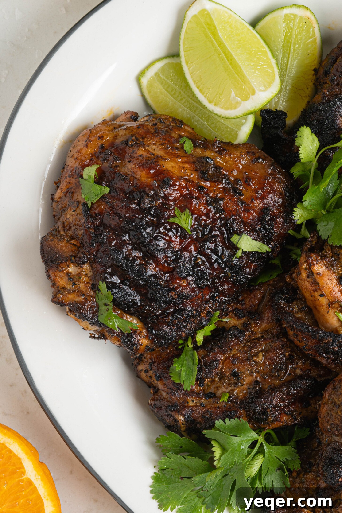 Flavorful Homemade Pollo Asado 10 A large serving platter piled high with expertly grilled Pollo Asado chicken pieces, ready to be carved and served.