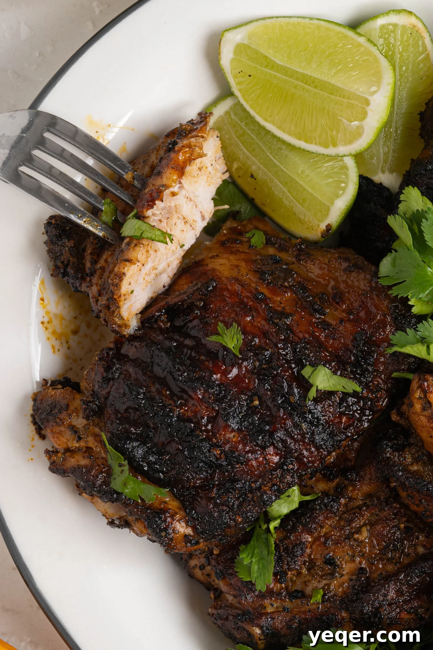 Flavorful Homemade Pollo Asado 8 A vibrant platter of freshly grilled Pollo Asado, garnished with lime wedges and cilantro, ready for serving.