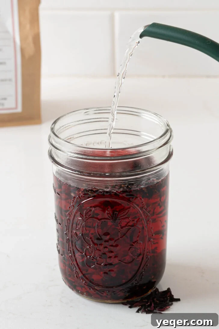 Hot water pouring over hibiscus flowers.
