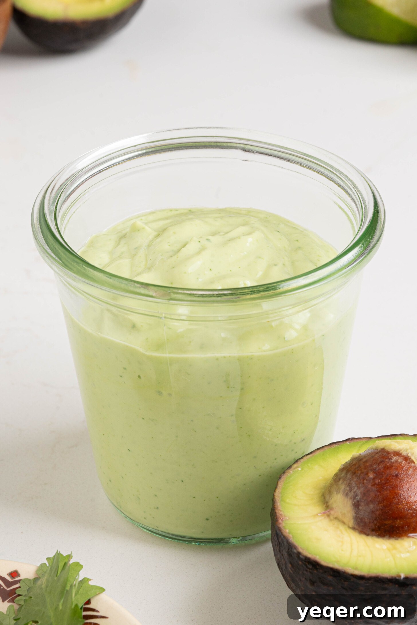Velvety Greek Yogurt Avocado Dip 7 A jar of creamy avocado dip, perfectly blended and ready for serving.