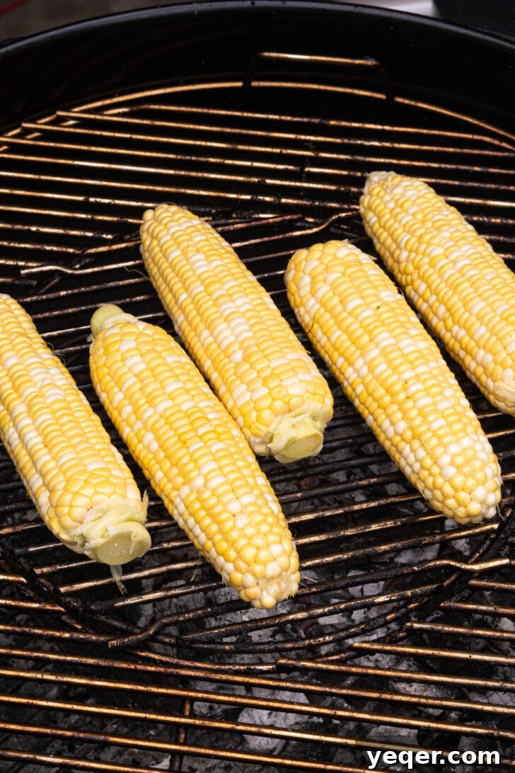 Grilled Mexican Street Corn Dip 5 Ears of corn charring on a hot grill, creating smoky flavor.