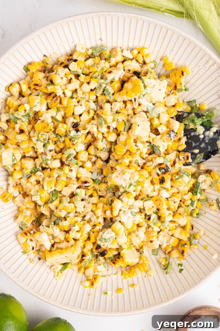 Grilled Mexican Street Corn Dip 8 A bowl of creamy Elote corn dip, perfectly mixed and ready to be served.