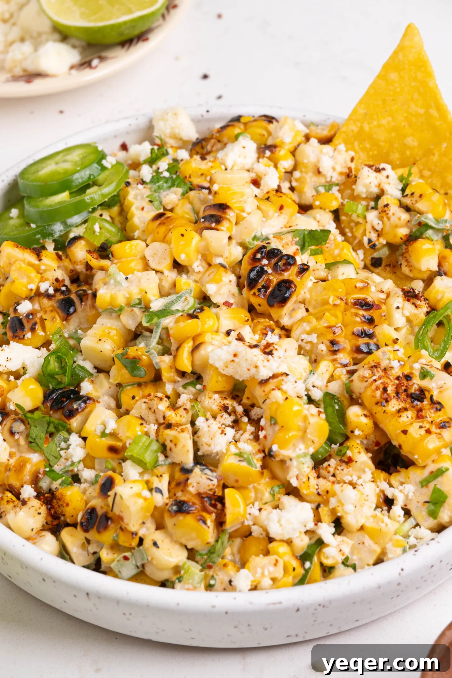 Grilled Mexican Street Corn Dip 9 A large, inviting bowl of Elote corn dip on a wooden table, garnished beautifully.