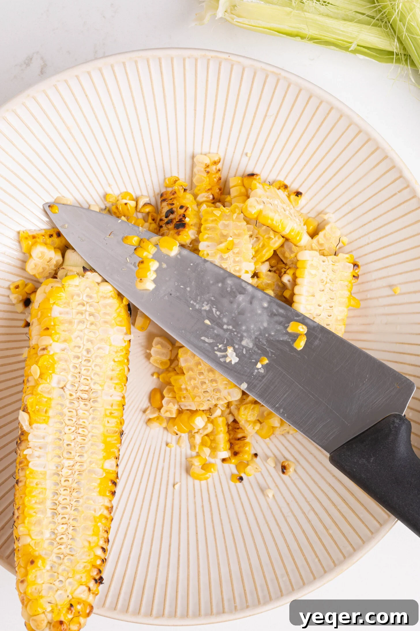 Grilled Mexican Street Corn Dip 3 Close-up of shucked corn ears on a hot grill, showing developing char marks.
