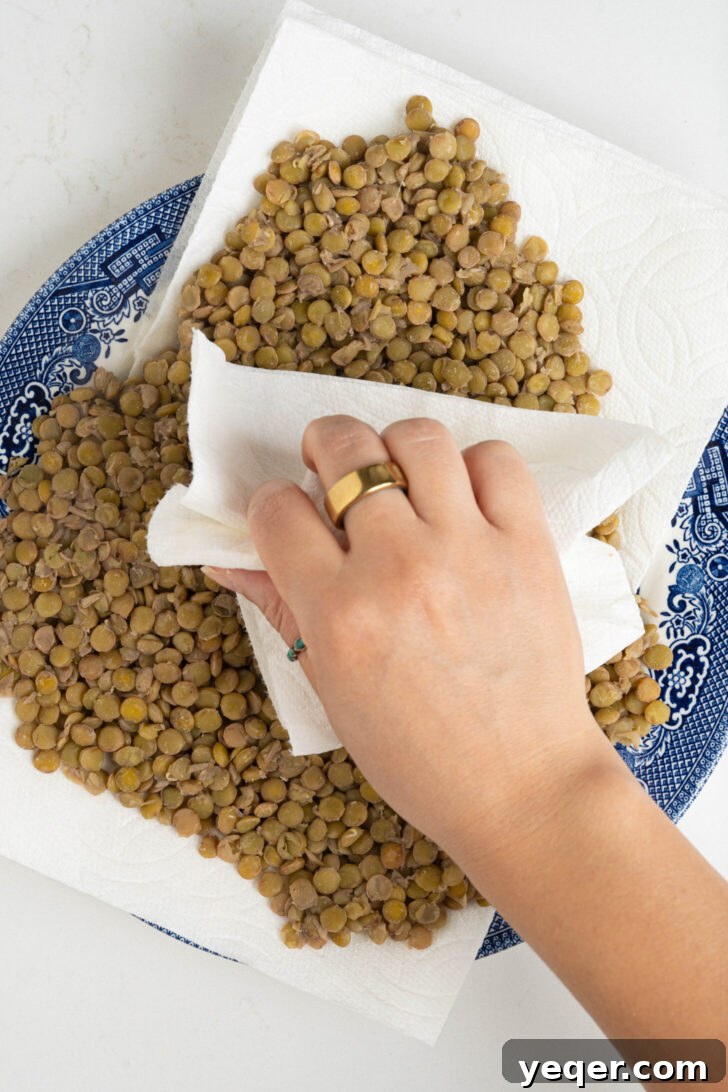 Golden Roasted Lentil Crisps 6 Cooked lentils being patted dry.