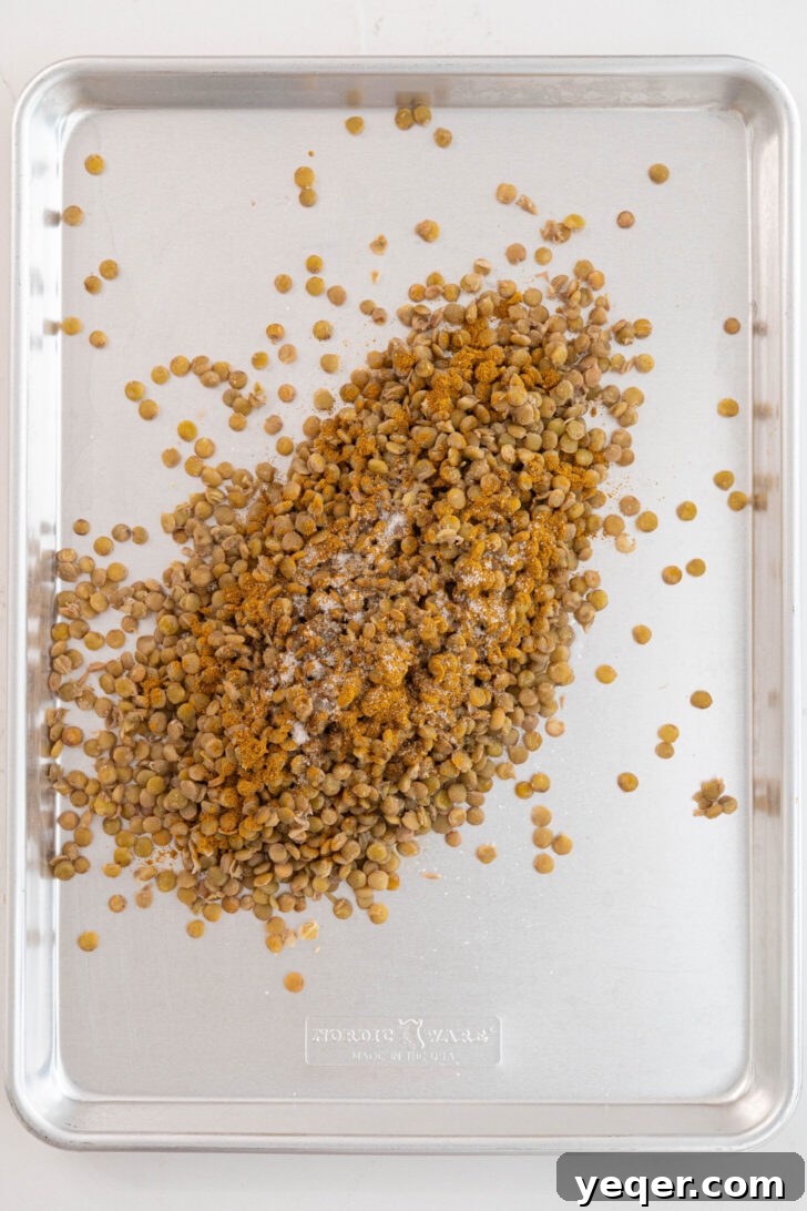 Golden Roasted Lentil Crisps 7 Lentils with spices on a baking sheet.