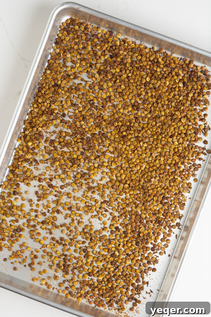 Golden Roasted Lentil Crisps 8 Crispy lentils on a baking sheet.