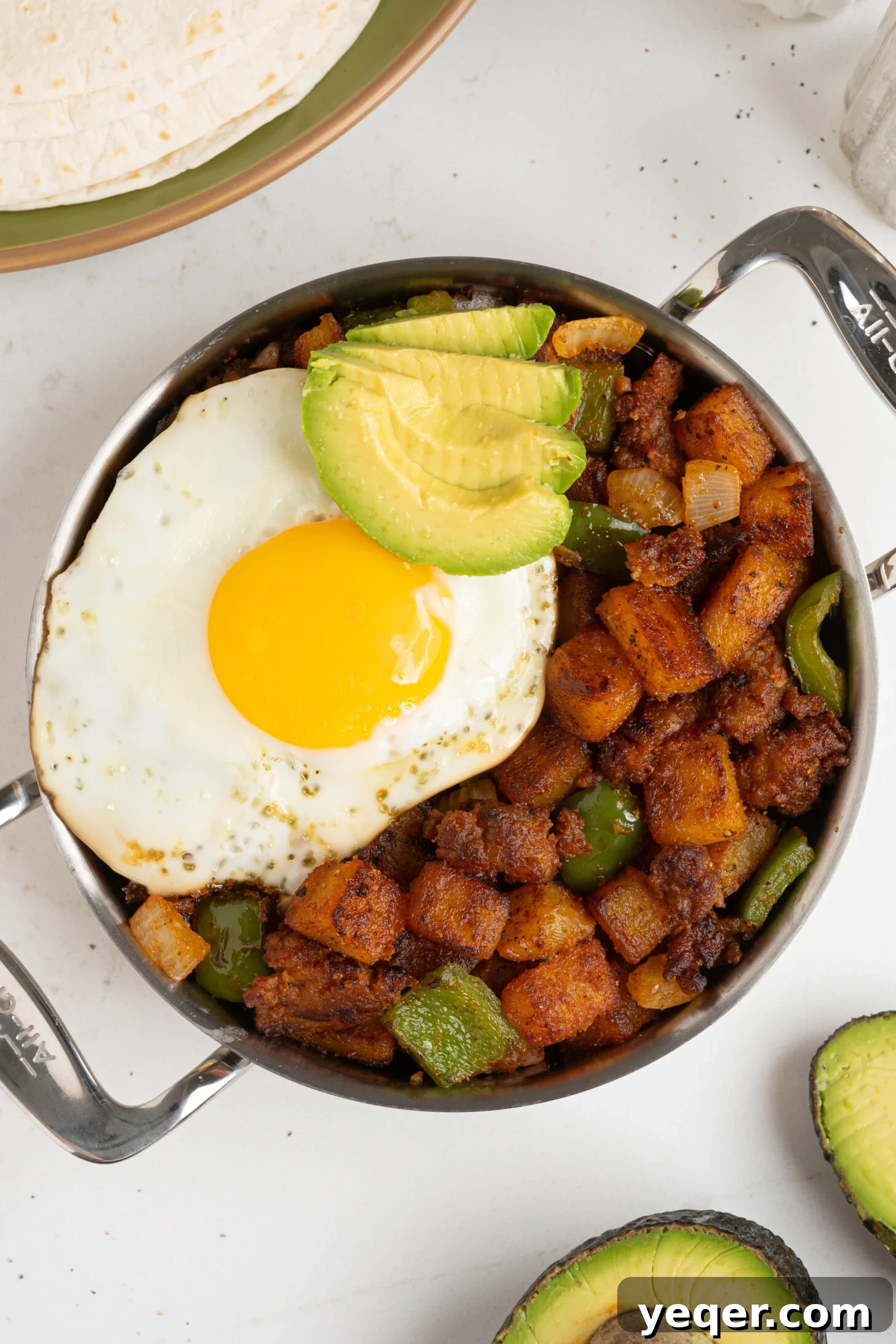 Savory Chorizo, Potato, and Egg Skillet 2 Chorizo breakfast hash sizzling in a cast-iron skillet, topped with fresh cilantro.