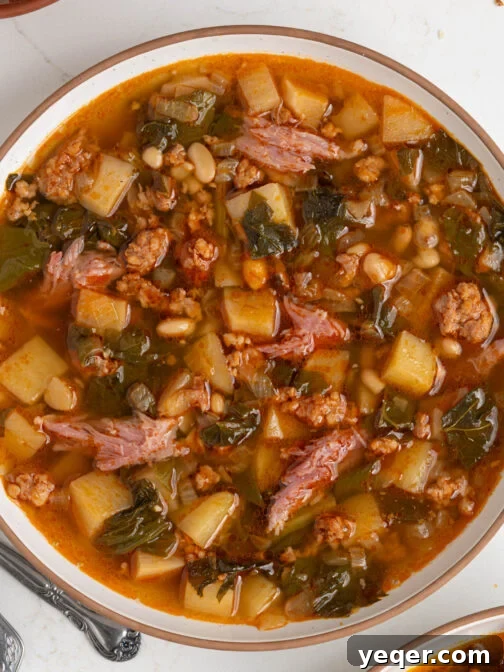 A bowl of Caldo Gallego, rich and steaming, ready to be enjoyed with a piece of crusty bread.