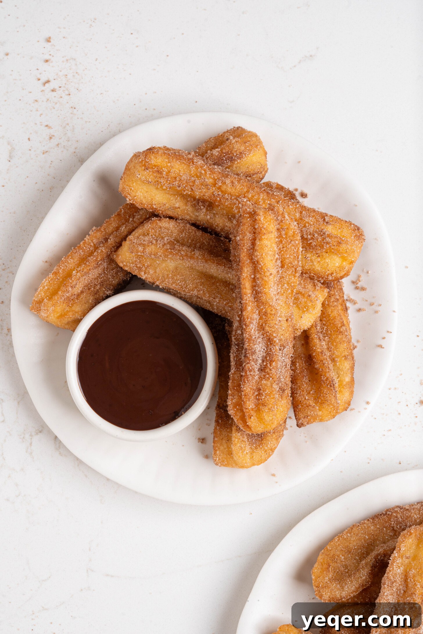 Homemade Golden Churros with Decadent Chocolate Sauce 13 A beautifully presented plate of homemade churros, ready to be shared.