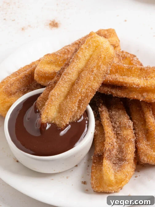 A plate of homemade churros, golden brown and perfectly textured.