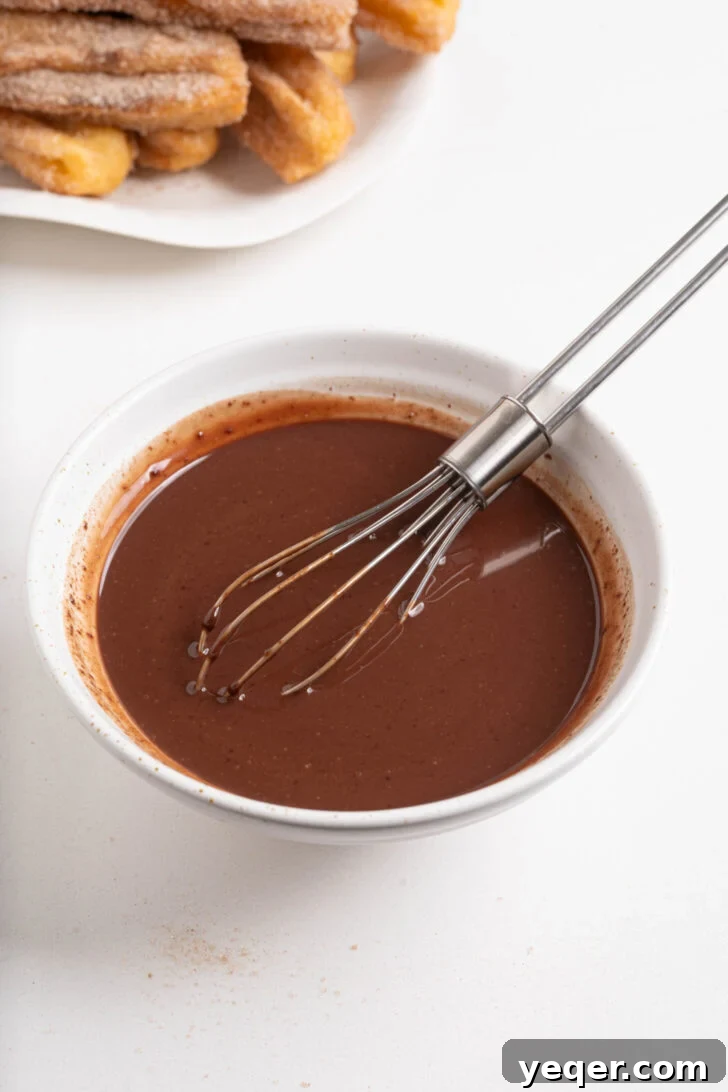 Homemade Golden Churros with Decadent Chocolate Sauce 10 A bowl of silky smooth chocolate dipping sauce, ready for churros.
