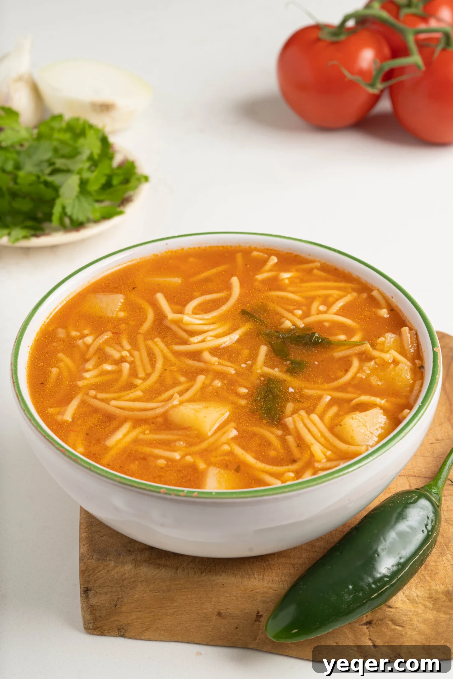 Vibrant Tomato Vermicelli Soup 3 Close-up of a bowl of Sopa de Fideo, highlighting the golden vermicelli noodles, chunks of potato, and rich, red tomato broth, ready to be served.