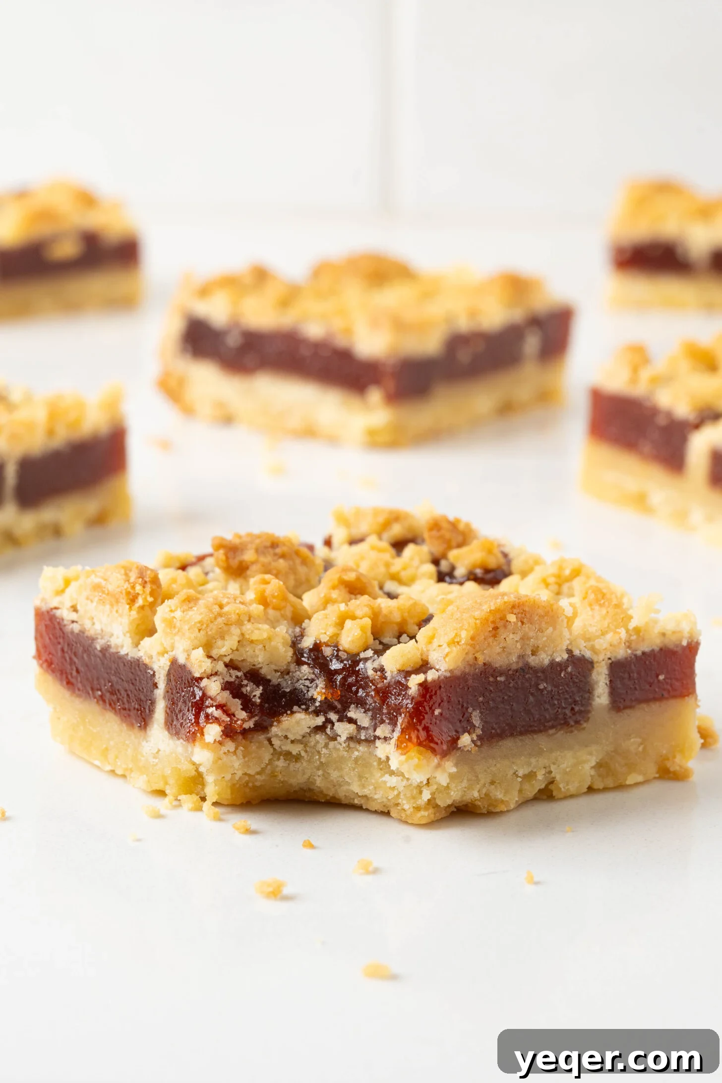 Golden Guava Crumble Bars 8 A close-up of a single, perfectly cut guava bar, showcasing its layers and crumbly topping.