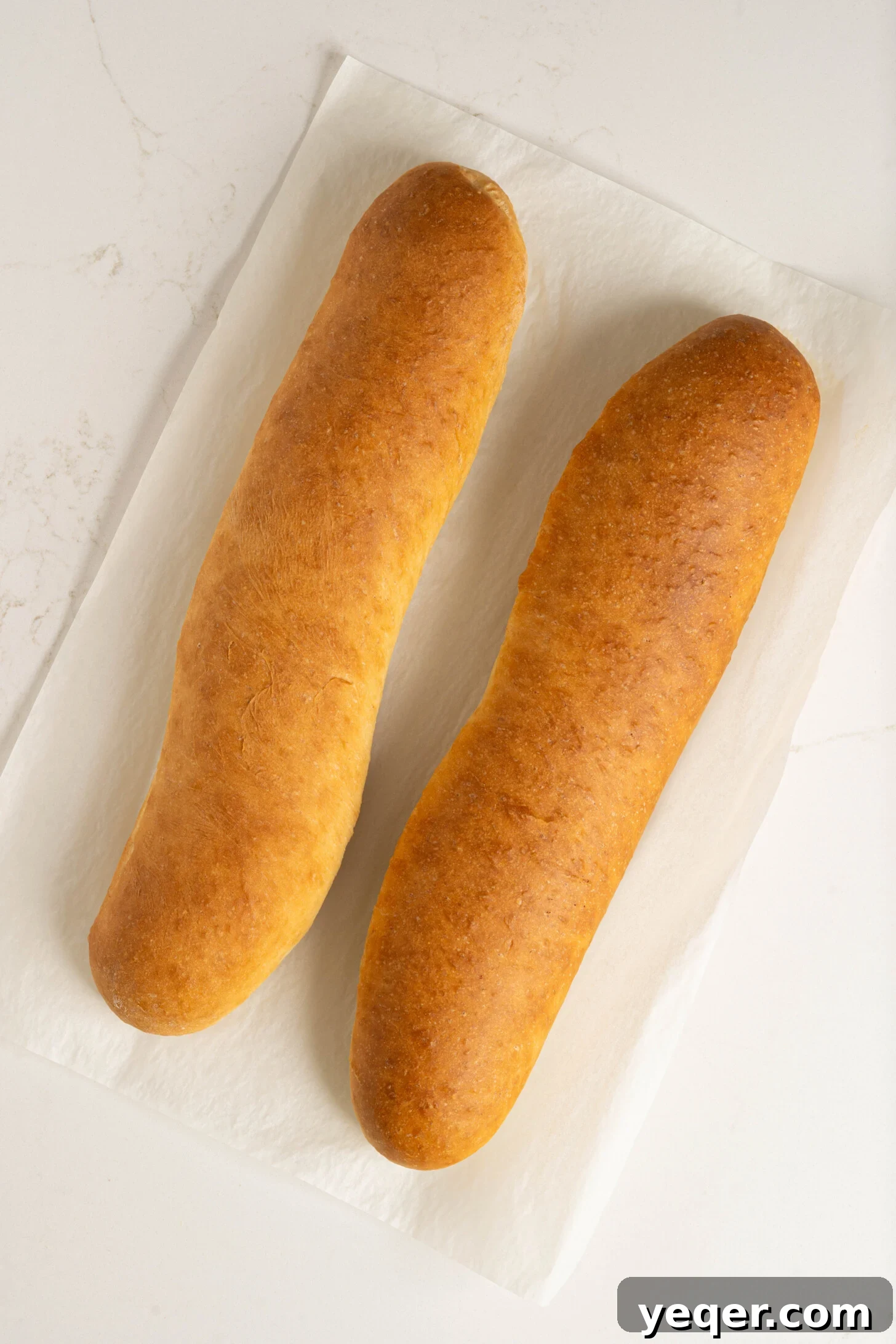Pan Sobao Puerto Rican Soft Sweet Bread 8 Two golden-brown loaves of pan sobao on a cooling rack.