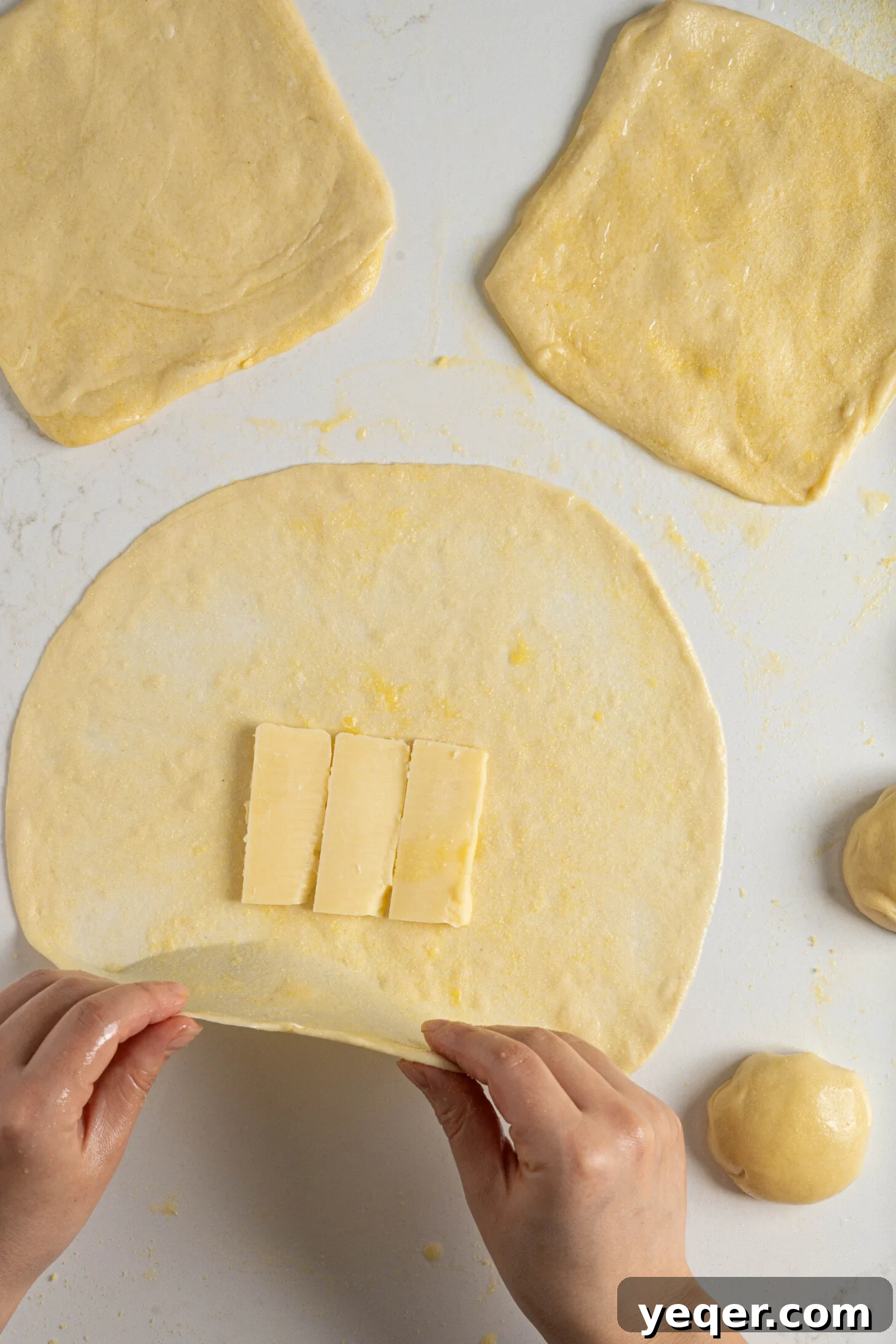 Msmen: Morocco's Iconic Flaky Flatbread 4 Cheese pieces carefully placed inside Msmen dough before folding.