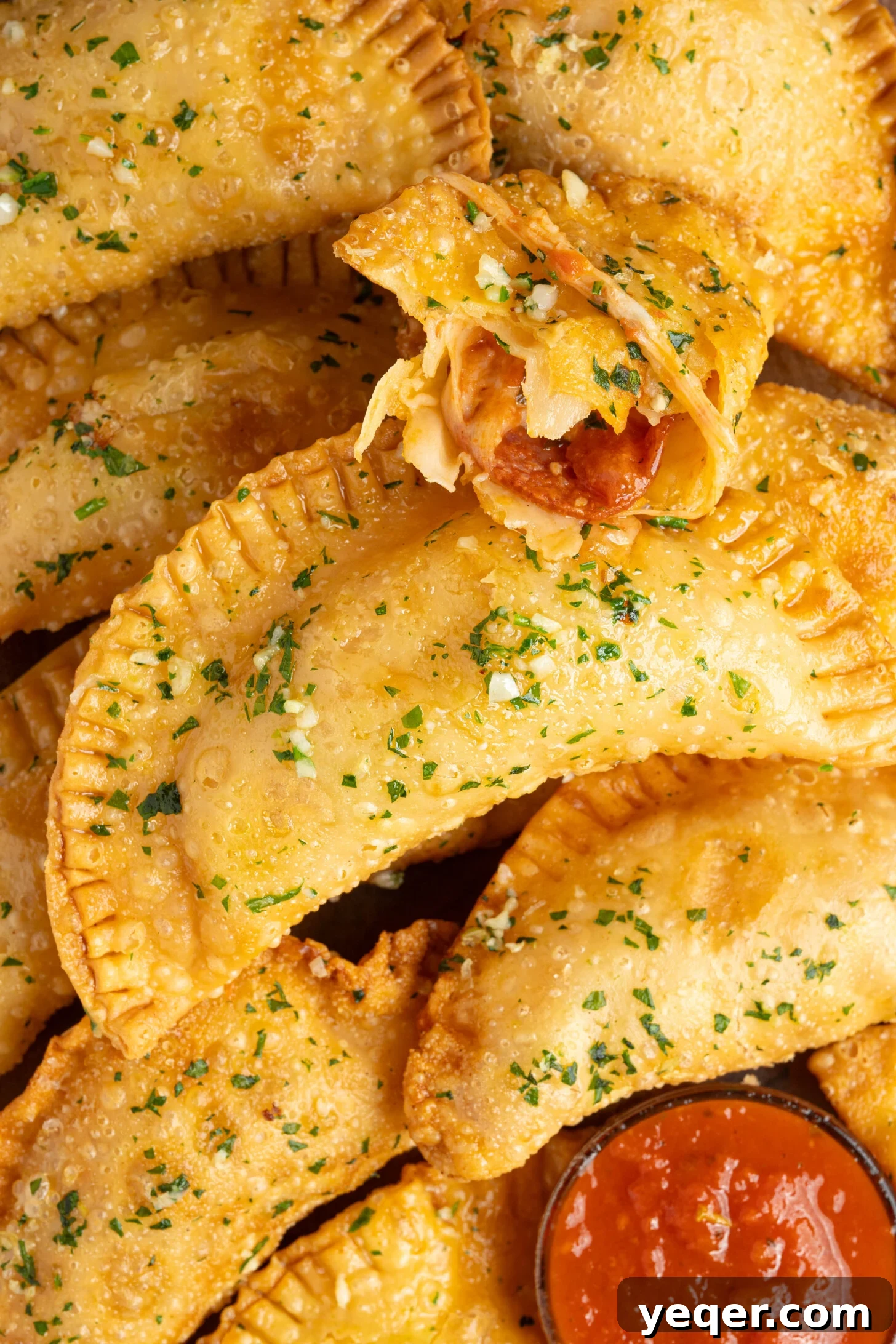 Quick Pizza Pockets 10 A beautifully presented plate of Pizza Empanadas, drizzled with garlic butter.
