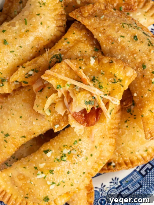 Crispy Pizza Empanadas on a plate with garlic butter.