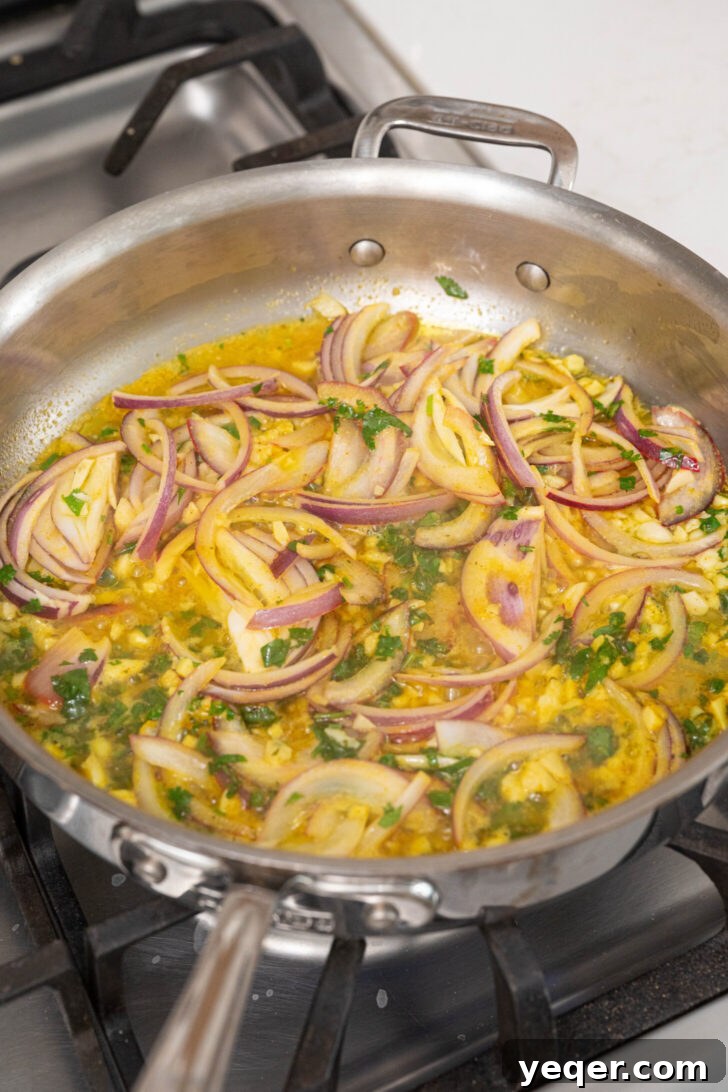Zesty Garlic Steamed Yuca 6 Sautéing julienned red onions, minced garlic, and adobo seasoning in olive oil in a pan.