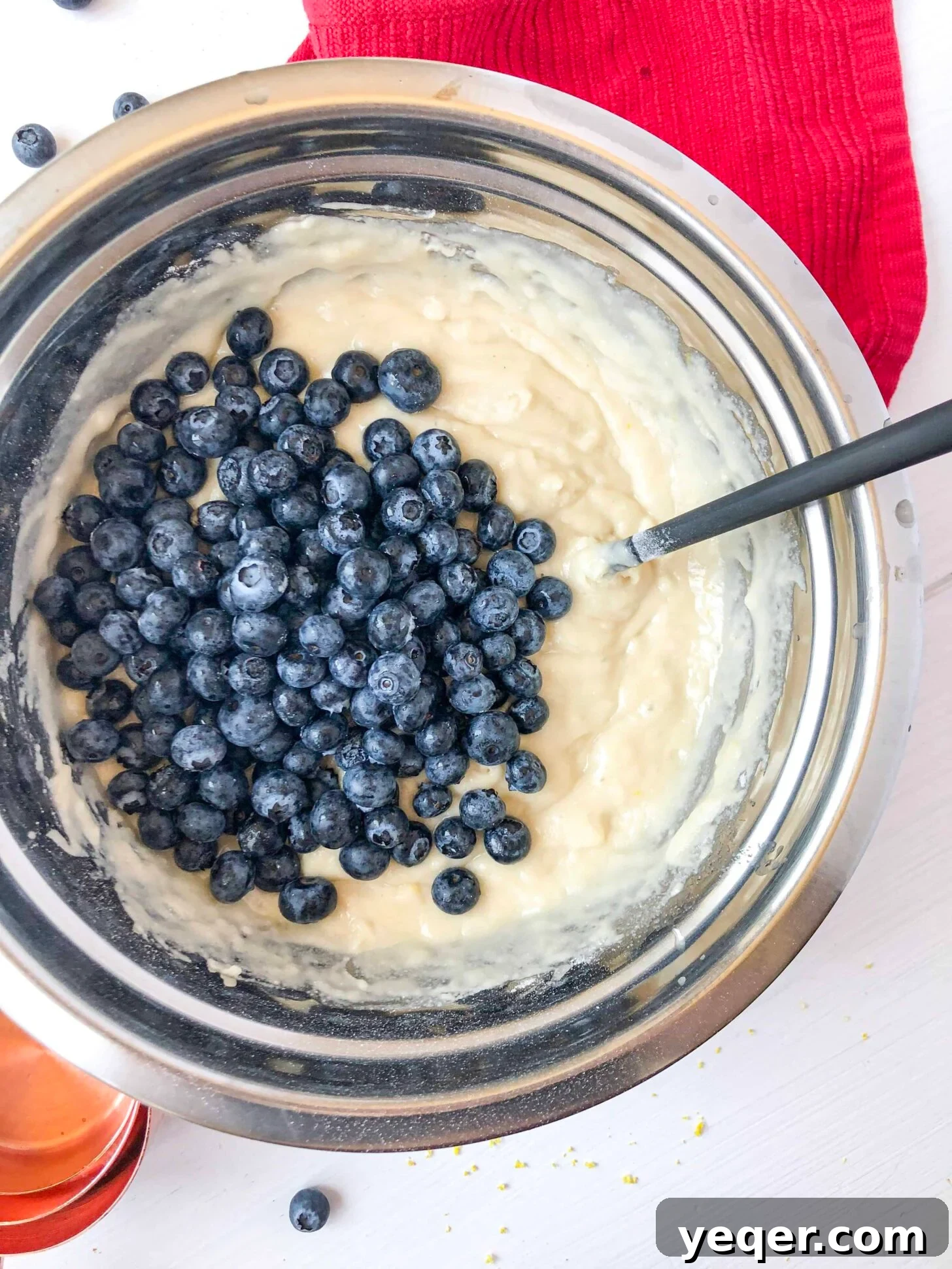 Irresistible Vegan Gluten-Free Blueberry Oat Muffins 3 A bowl of muffin batter with fresh blueberries