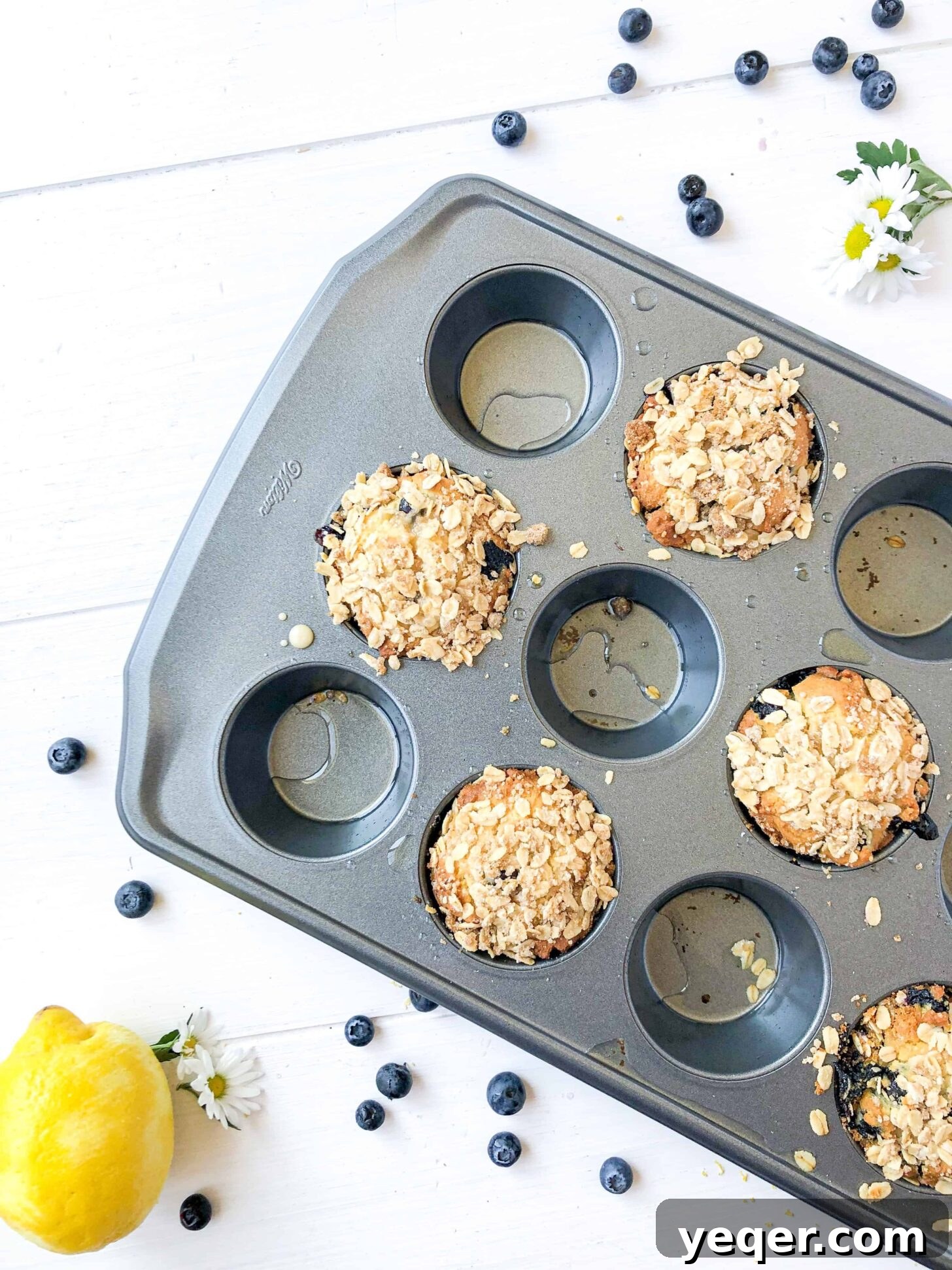 Irresistible Vegan Gluten-Free Blueberry Oat Muffins 4 A pan of vegan blueberry muffins with fresh blueberries