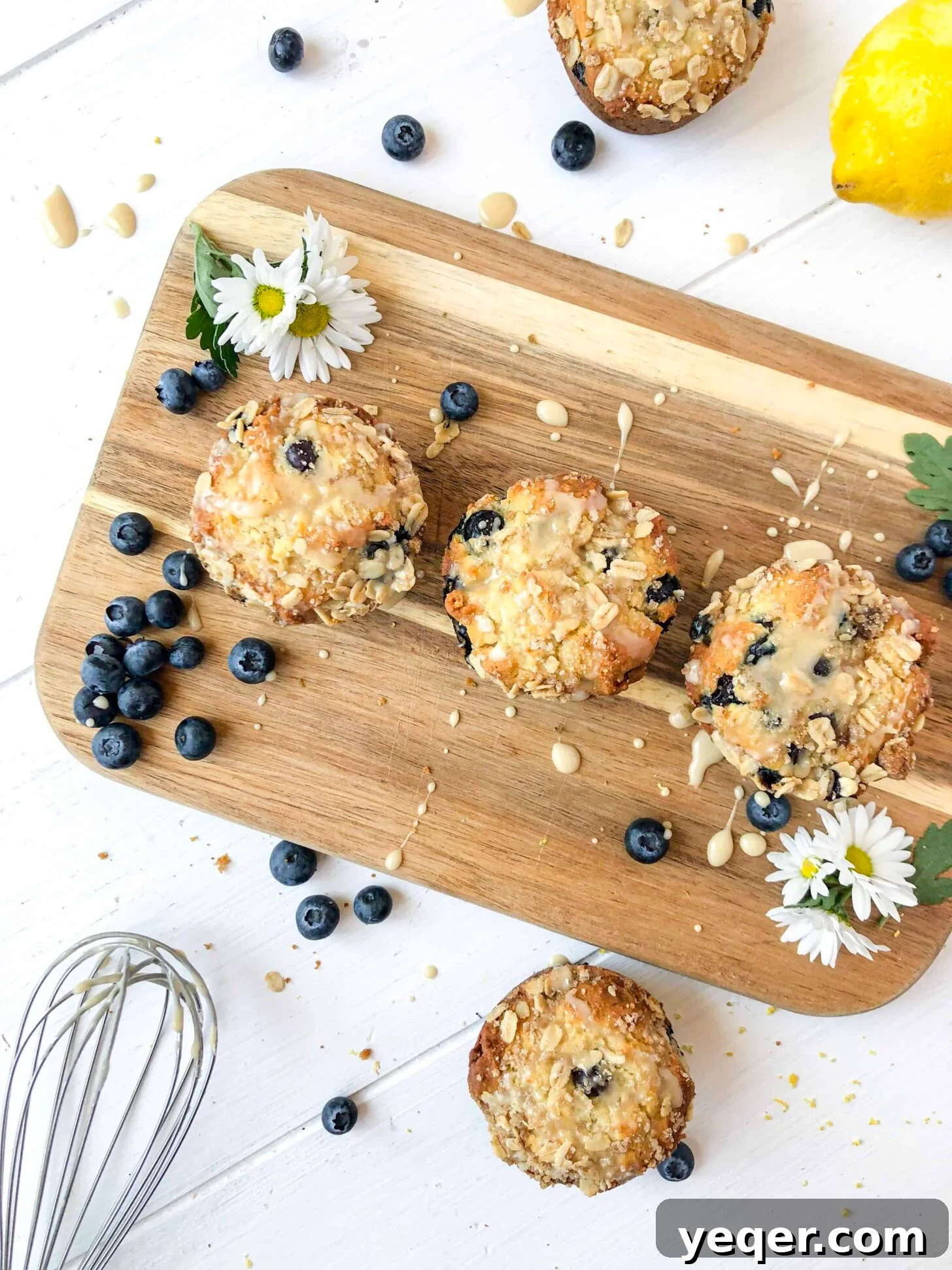 Irresistible Vegan Gluten-Free Blueberry Oat Muffins 6 Vegan blueberry muffins on a wooden board with a maple glaze