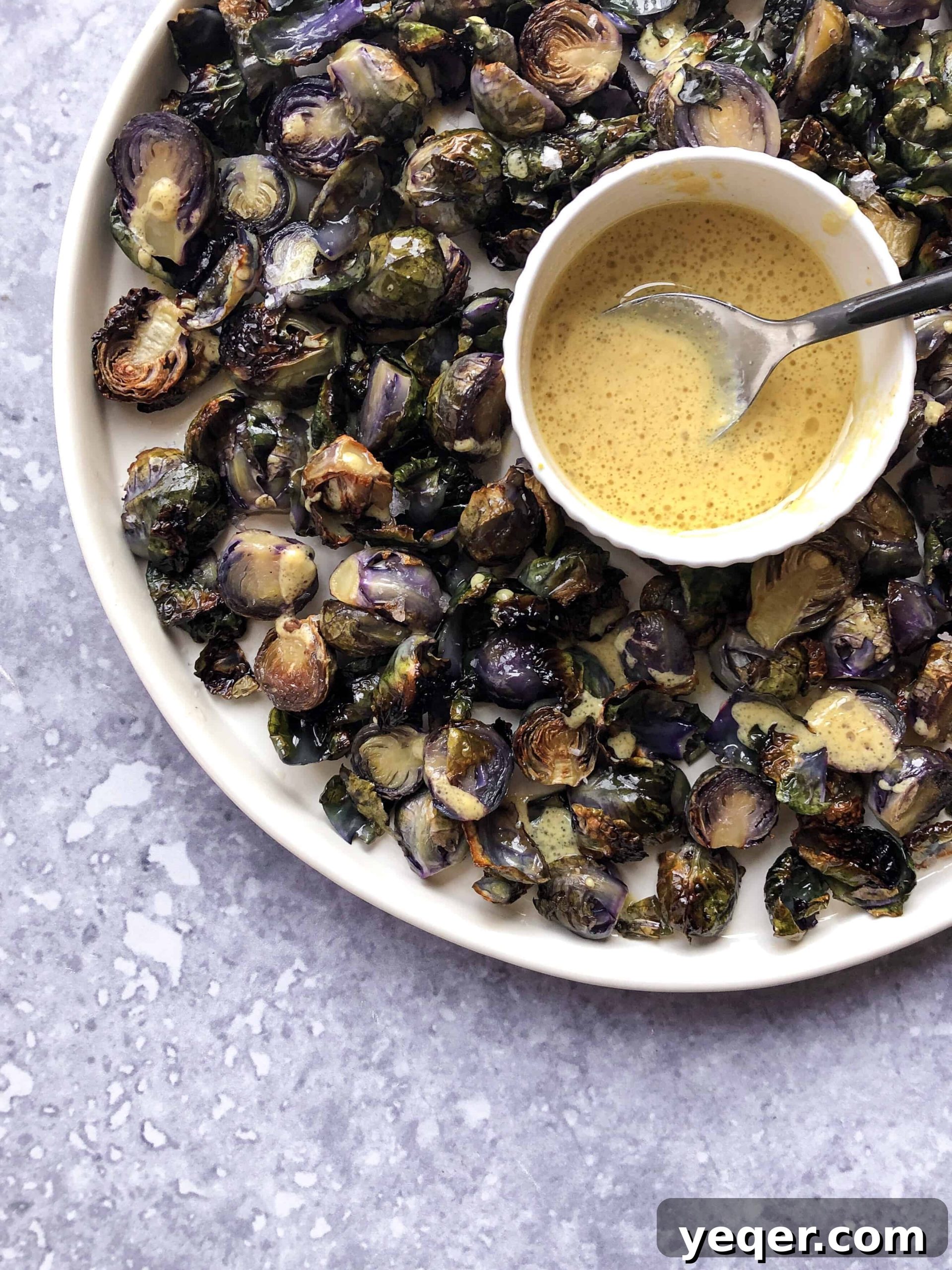 Zesty Lemon Dijon Brussels Sprouts 5 Platter of golden-brown lemon dijon brussels sprouts generously coated with the vibrant citrus sauce.