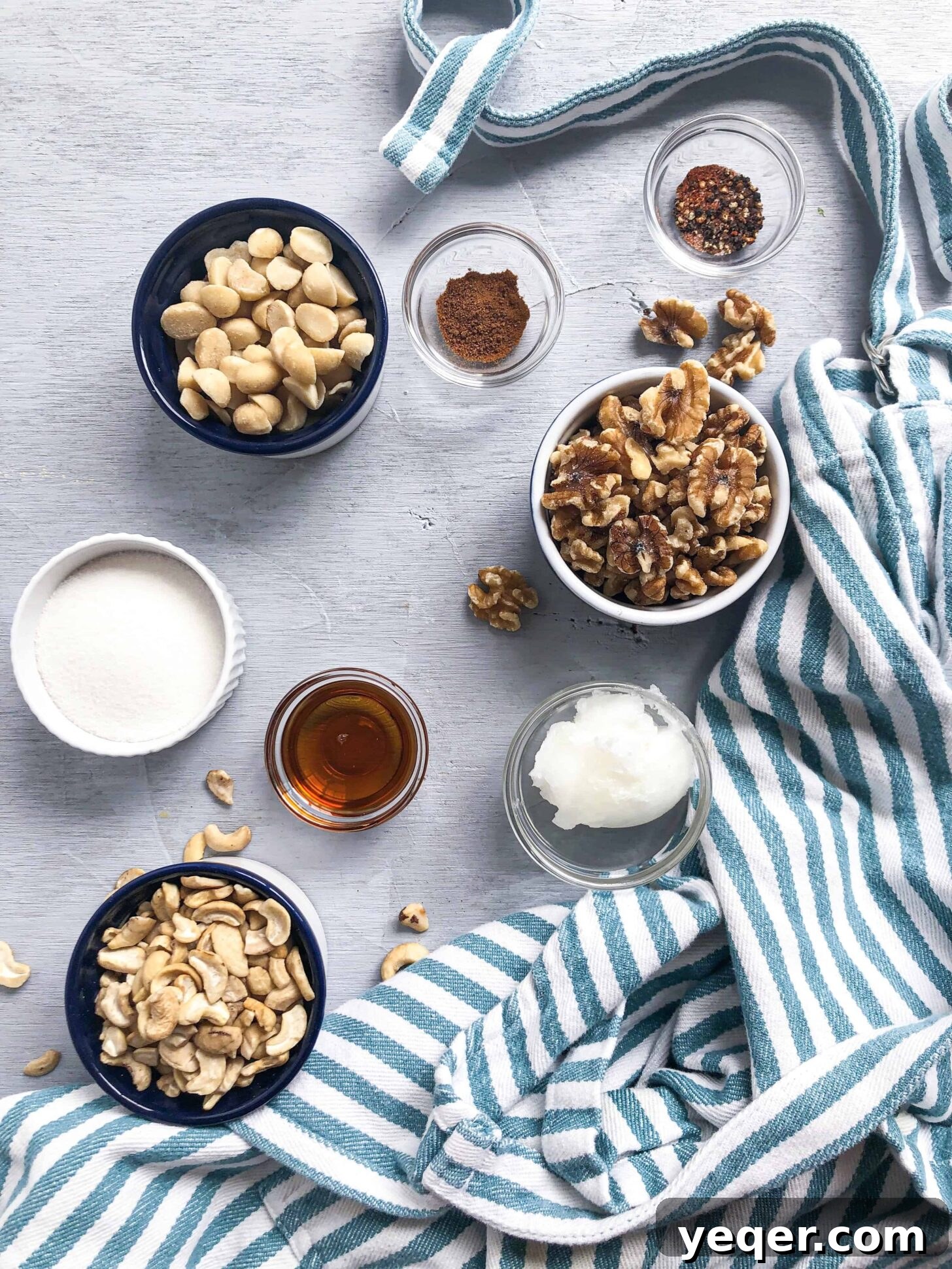 Artisan Spiced Nuts 3 A carefully arranged selection of ingredients, including various nuts, spices, and liquid sweeteners, ready for mixing.