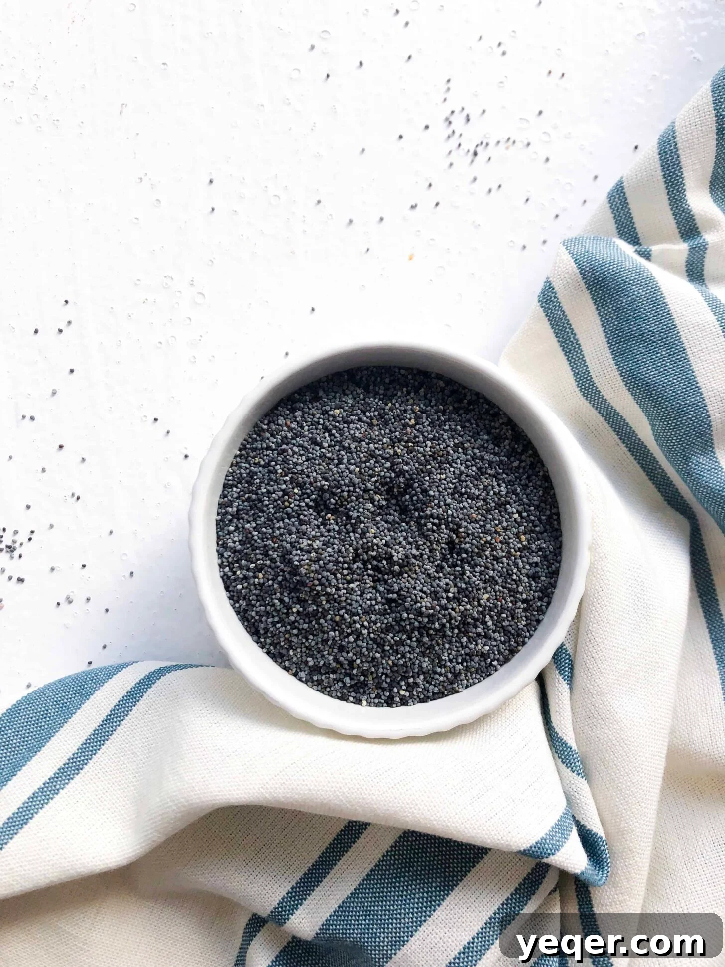Moist Gluten-Free Poppy Seed Muffins 3 A bowl filled with small, dark poppy seeds, ready for baking.